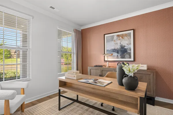 a dining room with furniture a window and wooden floor