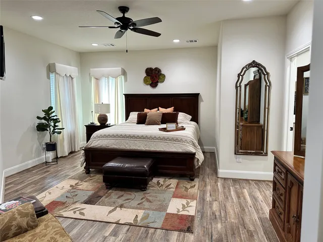 a bedroom with a large bed and a chandelier