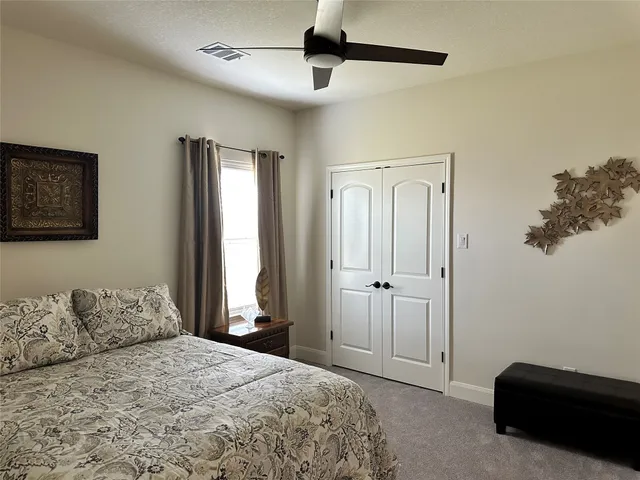 a bedroom with a bed and a walk in closet