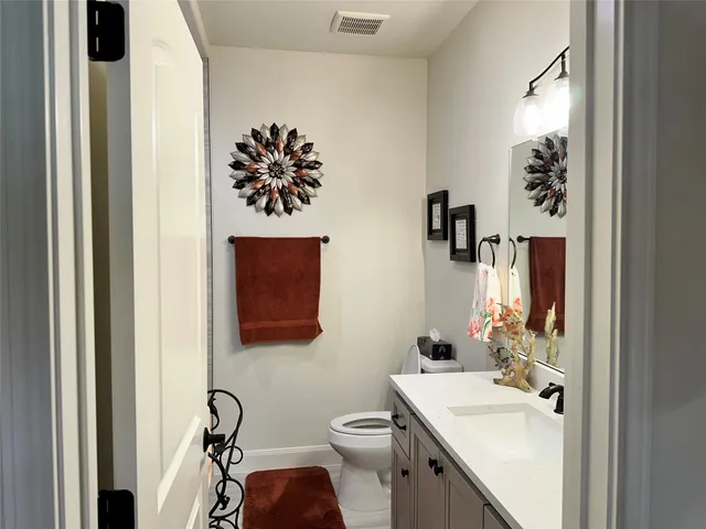 a bathroom with a sink a mirror and a toilet