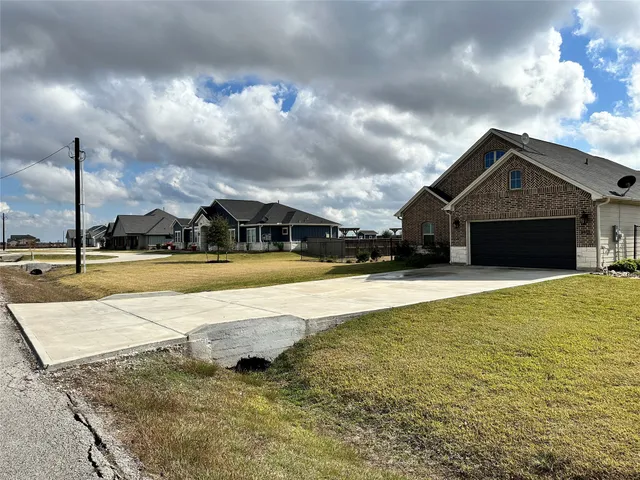 a view of a house with swimming pool and a yard