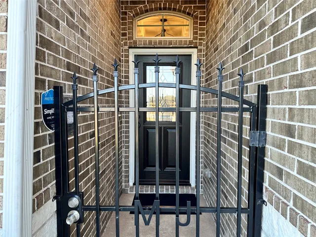 a view of a door and brick walls