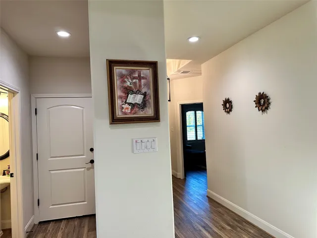 a view of a hallway with wooden floor and closet