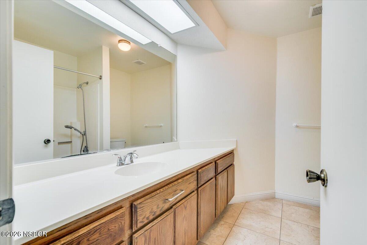 933 Bellflower Lane Lompoc, CA 93436 - Photo 11 of 17 a bathroom with a sink and a mirror