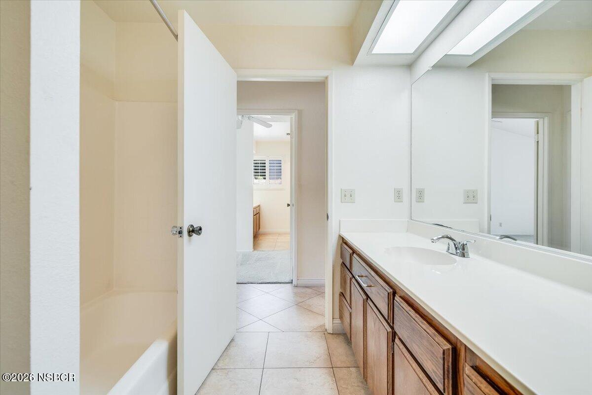 933 Bellflower Lane Lompoc, CA 93436 - Photo 12 of 17 a spacious bathroom with a sink and a mirror