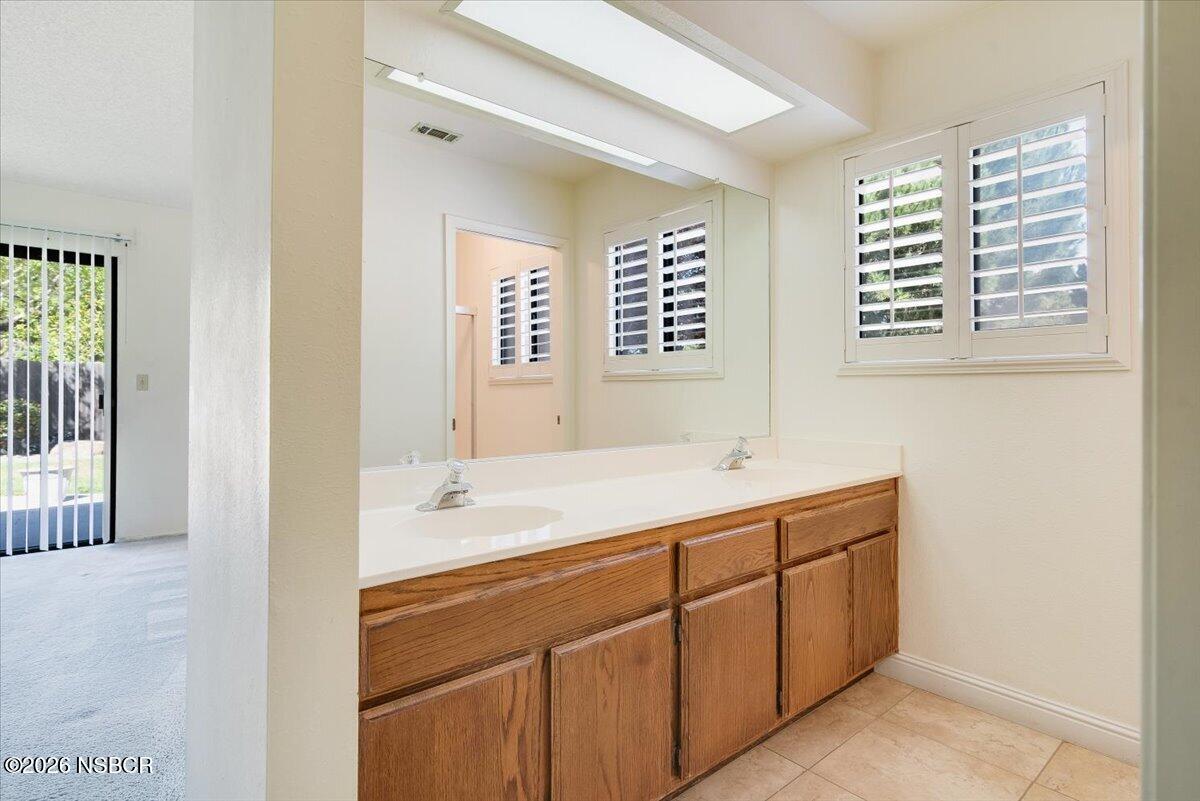 933 Bellflower Lane Lompoc, CA 93436 - Photo 14 of 17 a bathroom with a sink and a mirror
