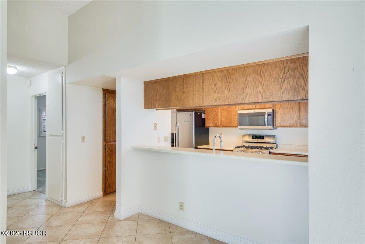 933 Bellflower Lane Lompoc, CA 93436 - Photo 6 of 17 a kitchen with stainless steel appliances a refrigerator and a stove top oven