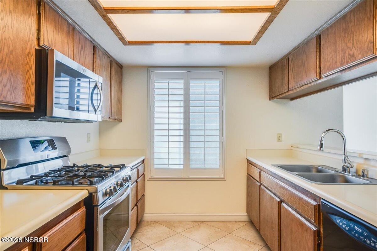 933 Bellflower Lane Lompoc, CA 93436 - Photo 7 of 17 a kitchen with a sink stove top oven and cabinets