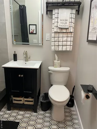 a bathroom with a toilet a sink and a mirror