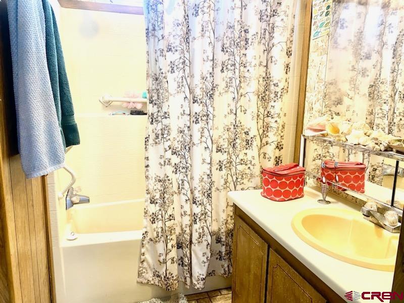 485 Florida Road, Unit B10 Durango, CO 81301 - Photo 16 of 19 a bathroom with a granite countertop sink and a mirror