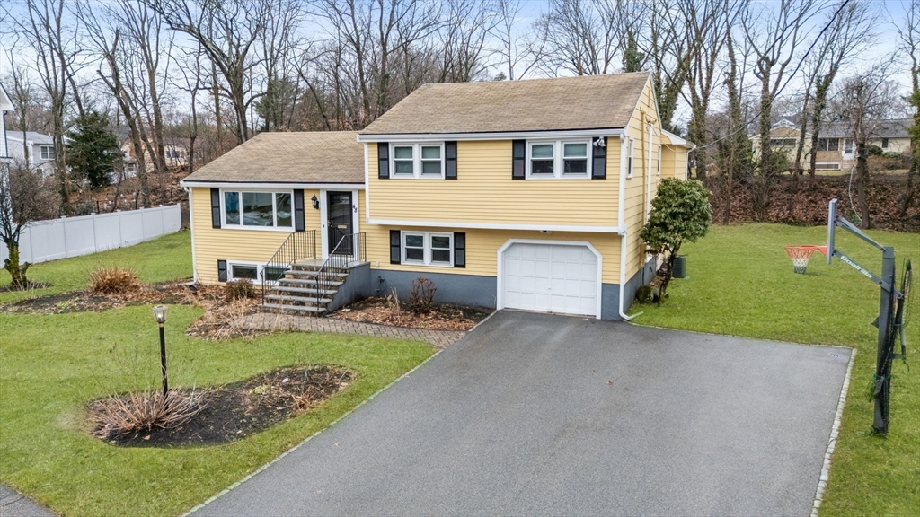 48 Gary Road Needham, MA 02494 - Photo 2 of 20 a front view of a house with garden