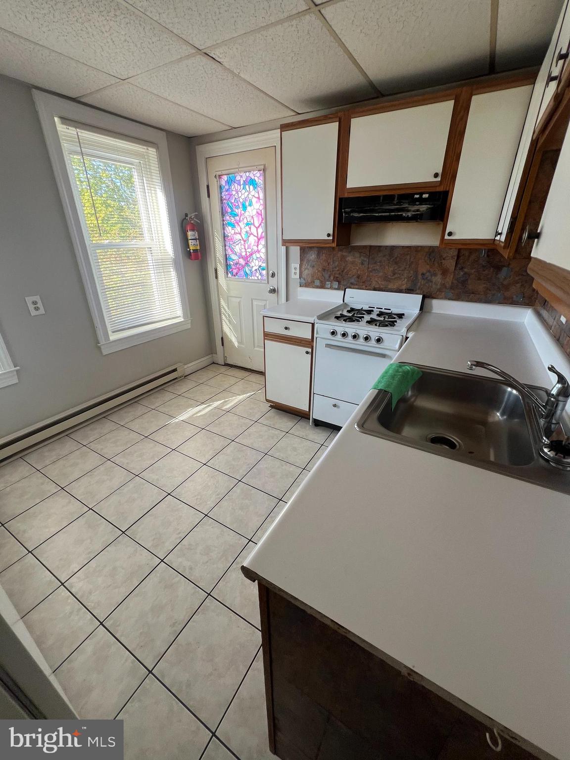 107 North York Street, Unit 3 Pottstown, PA 19464 - Photo 4 of 13 a kitchen with stainless steel appliances a stove a sink and a refrigerator