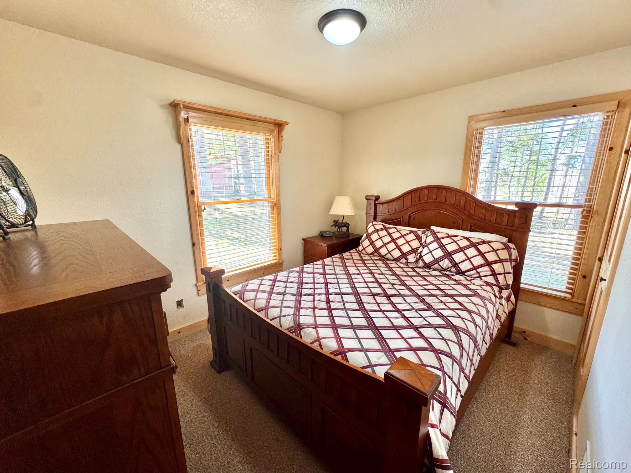 10931 North Roberts Road Frederic, MI 49733 - Photo 17 of 33 Bedroom featuring carpet flooring and a textured ceiling