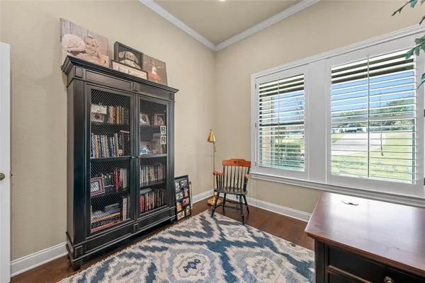 a living room with fish tank and a window