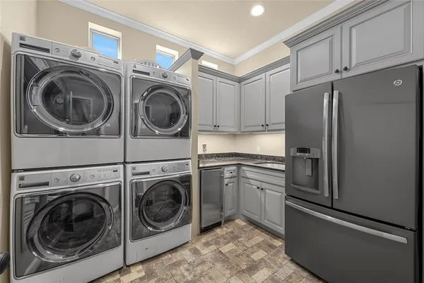 a utility room with sink dryer and washer