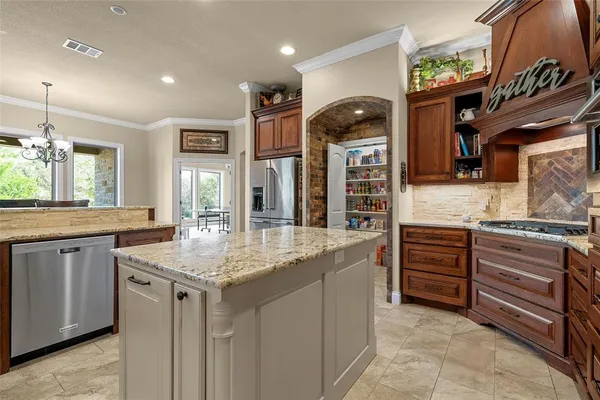 a kitchen with stainless steel appliances granite countertop a sink and dishwasher a stove with wooden floor
