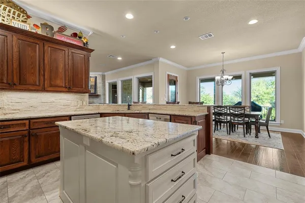 a kitchen with a stove a refrigerator and a dining table