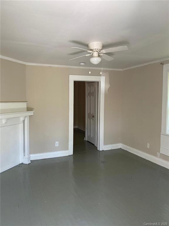 145 Lore Street Southwest Concord, NC 28025 - Photo 3 of 9 an empty room with a ceiling fan and window
