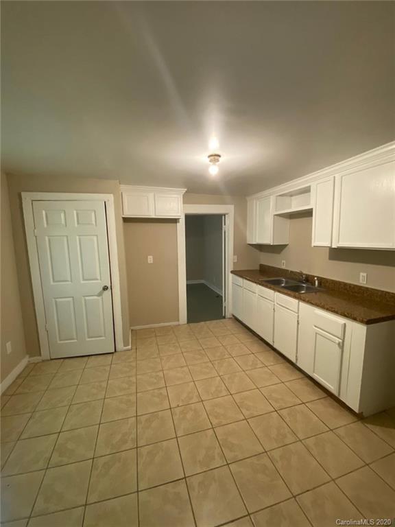 145 Lore Street Southwest Concord, NC 28025 - Photo 7 of 9 a view of a kitchen with a sink and a refrigerator