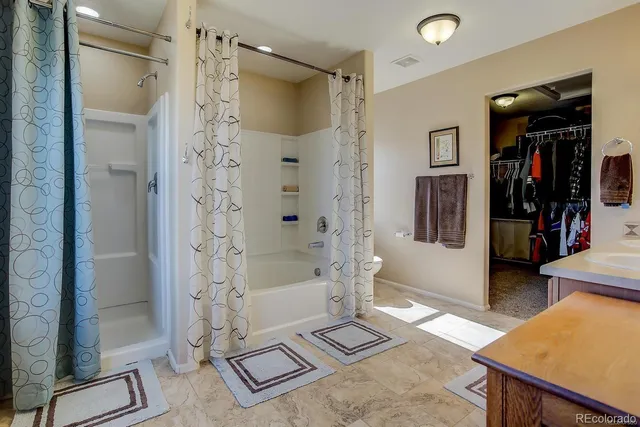 a spacious bathroom with a shower and a glass door