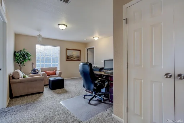 a bedroom with a bed lamp and window