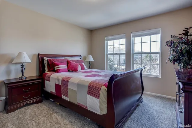 a bedroom with two beds and a large window