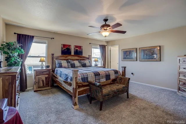 a bedroom with a bed couch and a window