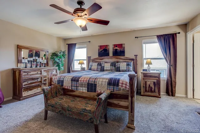 a living room with furniture a flat screen tv and a window