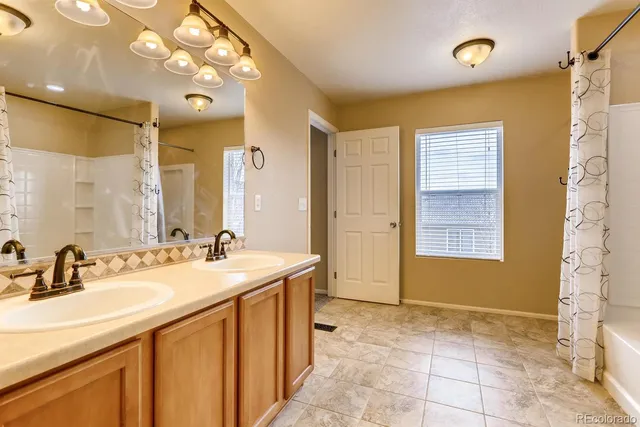 a bathroom with a sink vanity and a mirror