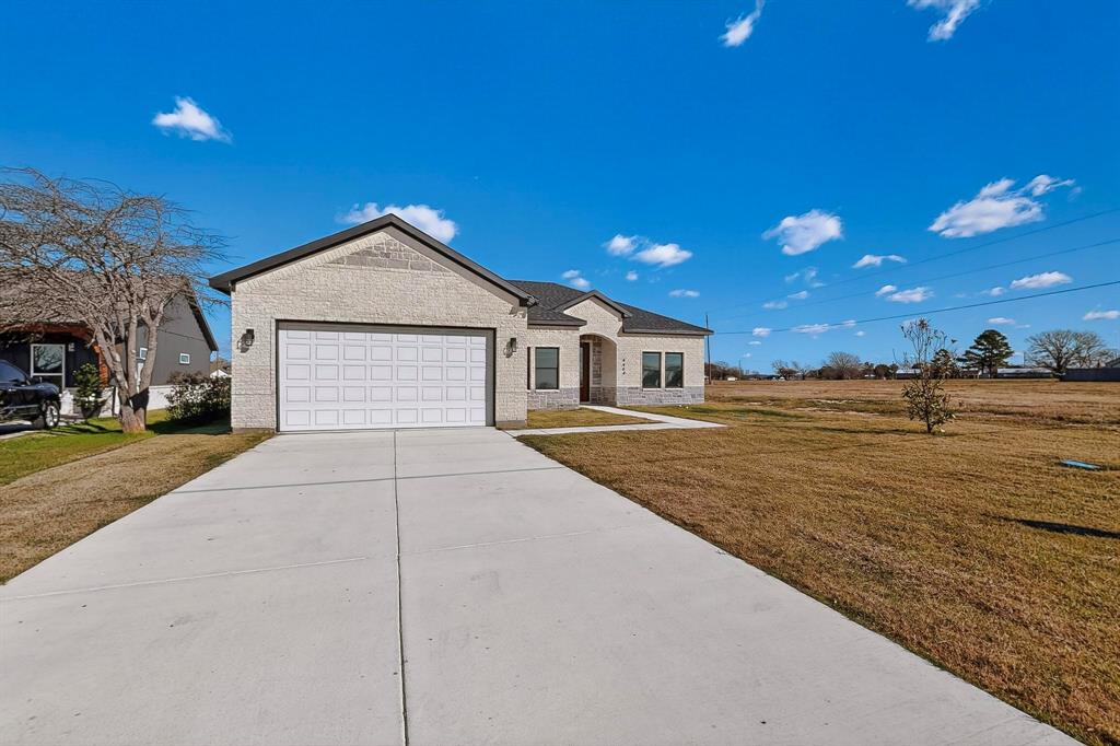 4464 Key Ranch Road Trinidad, TX 75163 - Photo 4 of 40 View of front of property with a front lawn, concrete driveway, brick siding, and an attached garage