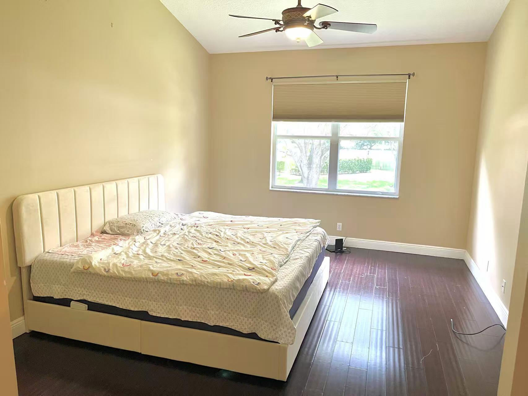 8550 Vía Romana, Unit 2 Boca Raton, FL 33496 - Photo 12 of 28 a bed sitting in a bedroom next to a window