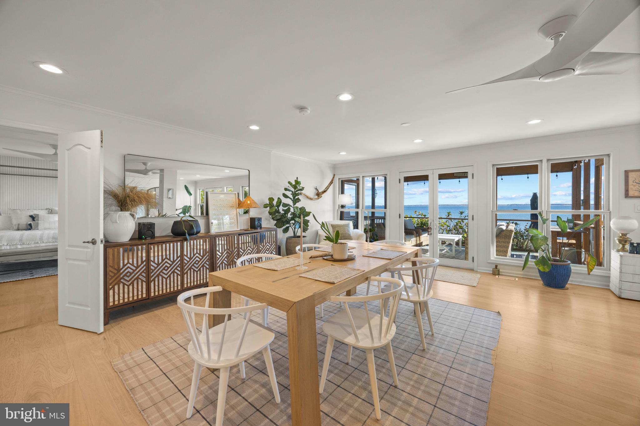806 Monroe Manor Road Stevensville, MD 21619 - Photo 14 of 41 a view of a dining room and livingroom with furniture wooden floor and a rug