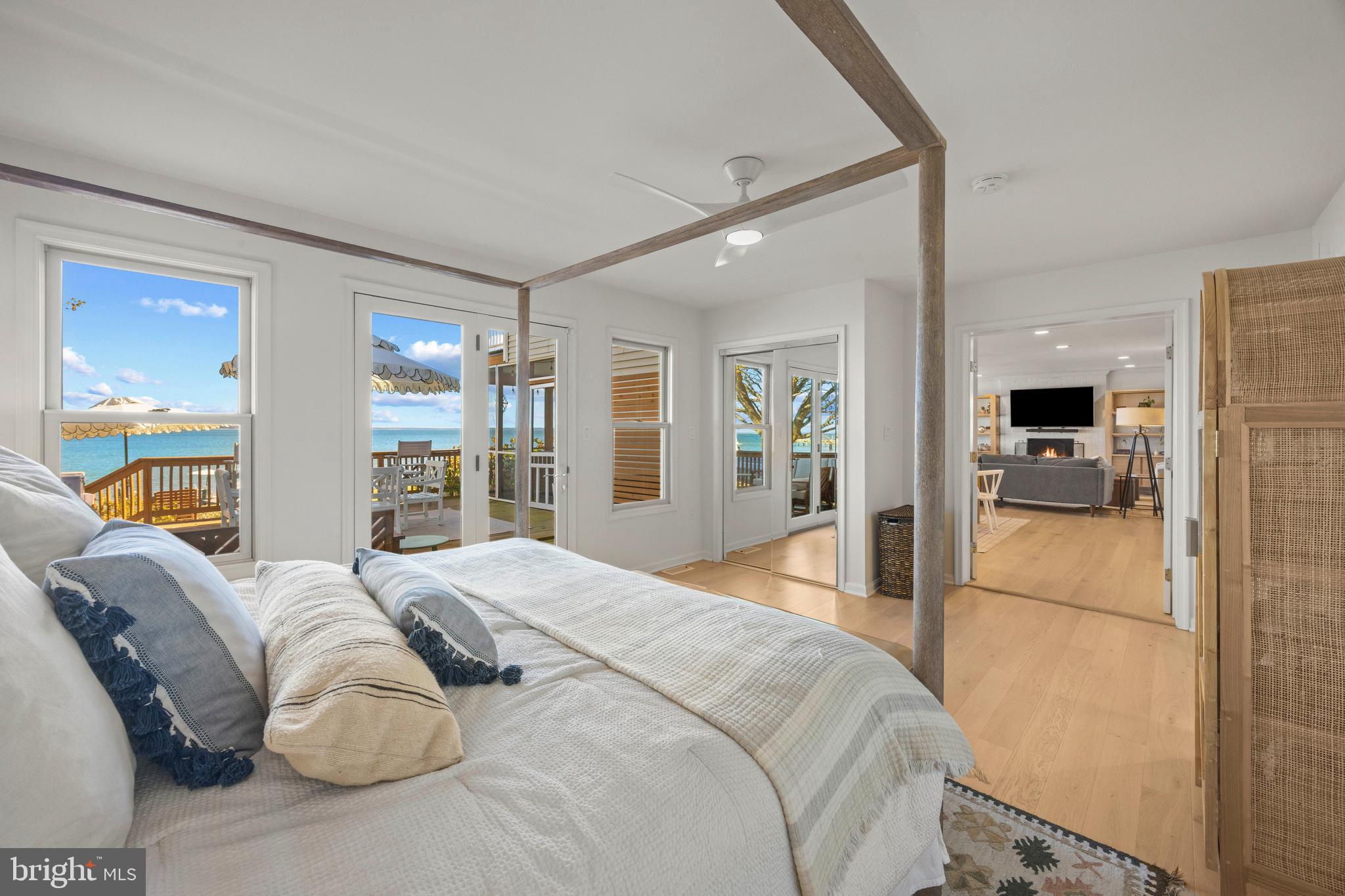 806 Monroe Manor Road Stevensville, MD 21619 - Photo 17 of 41 a bedroom with a large bed and a view of living room