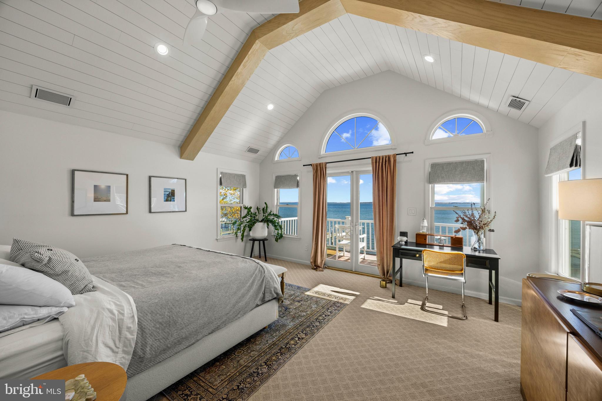 806 Monroe Manor Road Stevensville, MD 21619 - Photo 22 of 41 a bedroom with a bed and a chandelier