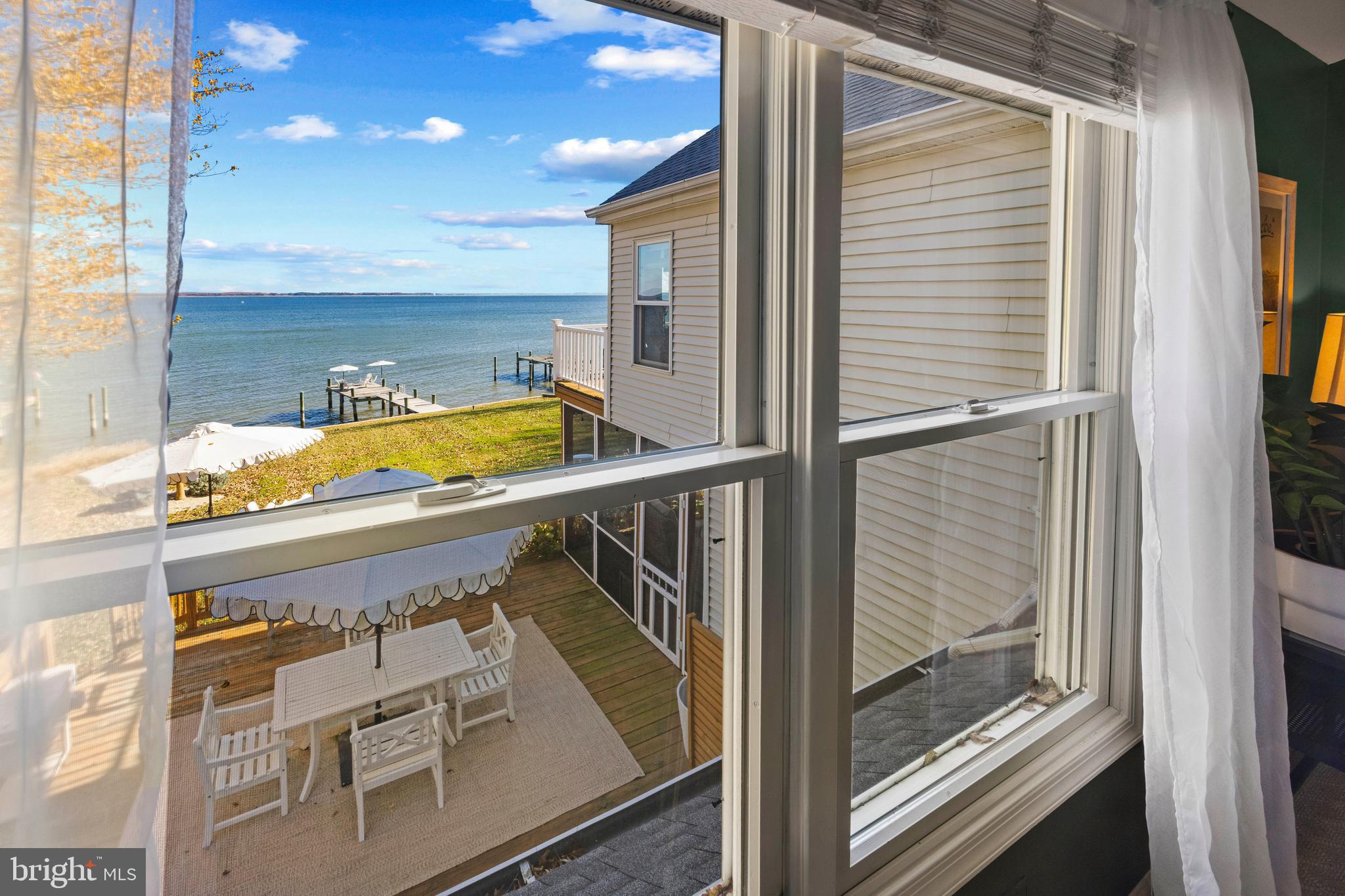806 Monroe Manor Road Stevensville, MD 21619 - Photo 26 of 41 a view of a balcony with furniture and floor to ceiling window