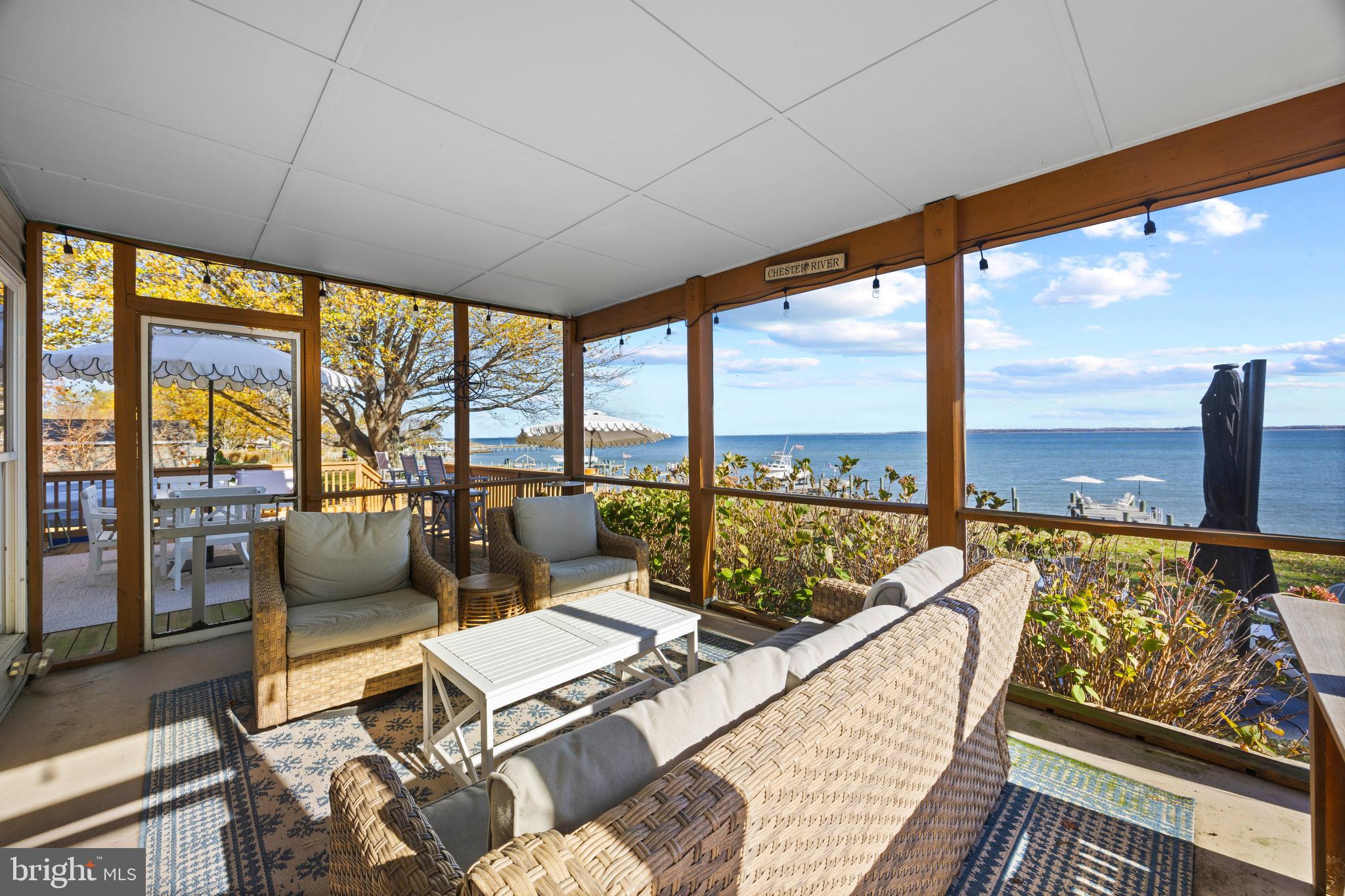 806 Monroe Manor Road Stevensville, MD 21619 - Photo 7 of 41 a living room with furniture and floor to ceiling windows