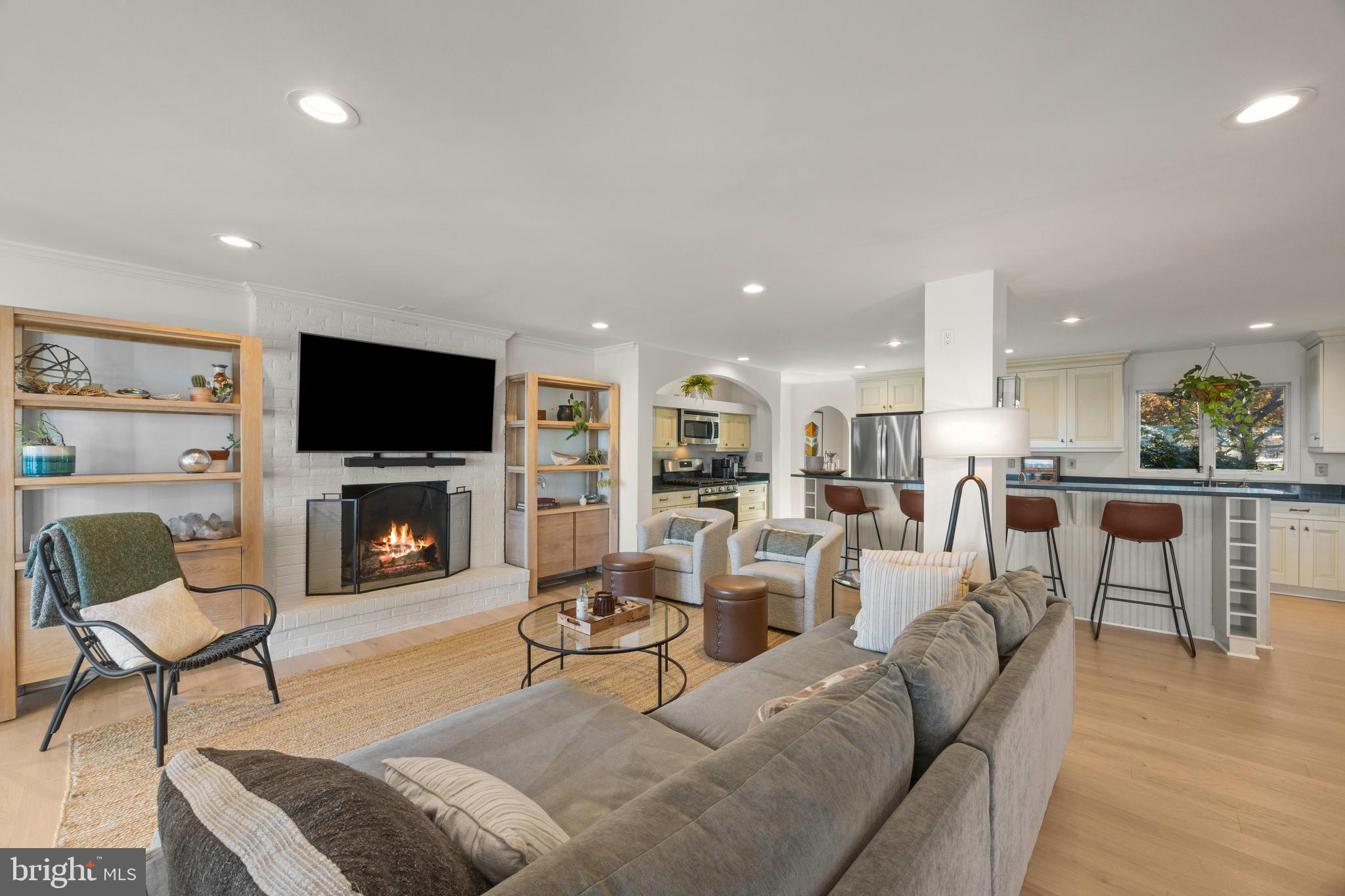 806 Monroe Manor Road Stevensville, MD 21619 - Photo 8 of 41 a living room with furniture a flat screen tv and a fireplace