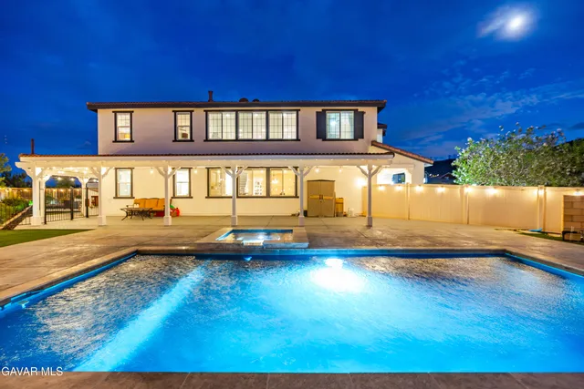 a view of a balcony with chairs and potted plants