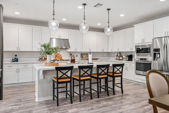 a spacious bedroom with a bed and a chandelier