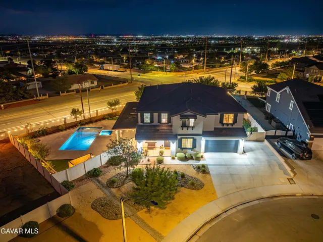 a living room with furniture a fireplace and a large window