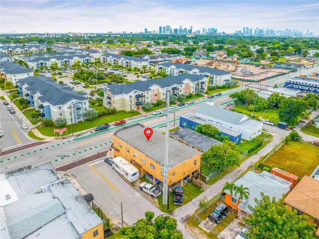 an aerial view of residential houses with outdoor space and street view