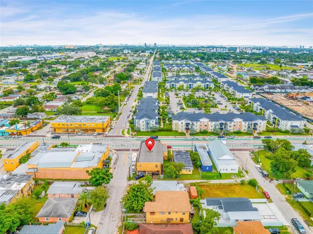 an aerial view of residential houses with outdoor space