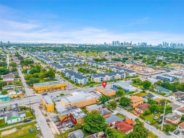 an aerial view of residential houses with outdoor space and street view
