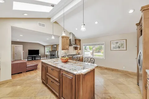 a kitchen with a stove a counter top space and a center island