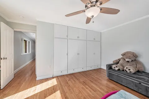 a bed room with a bed and a ceiling fan