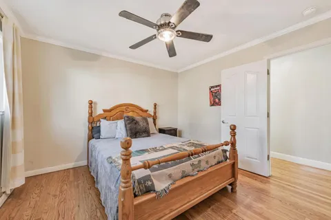 a bedroom with a bed and wooden floor