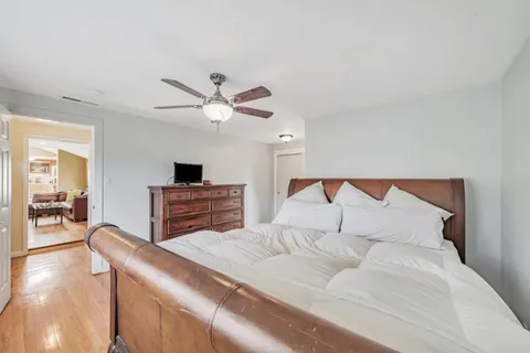 a bedroom with a large bed and a chandelier