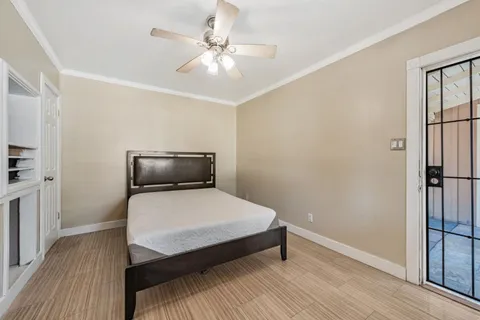 a bedroom with a bed and wooden floor