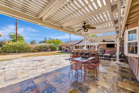 a view of a patio with table and chairs and potted plants