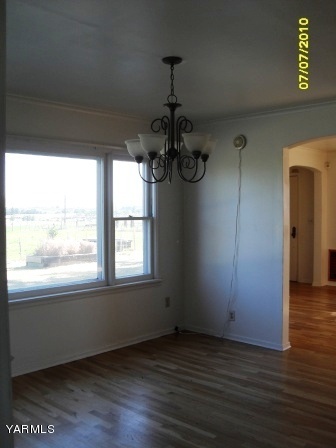 442 Hatton Road Tieton, WA 98947 - Photo 2 of 8 an empty room with wooden floor fan and windows
